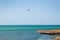 Airplane descends over sailboat horizon seascape