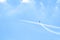 Airplane doing acrobatics in blue sky leaves a smoke. Blue sky with airport contrail clouds