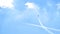 Airplane doing acrobatics in blue sky leaves a smoke. Blue sky with airport contrail clouds