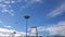 A airplane flies in a blue cloudy sky