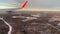 Airplane flight. Aircraft's wing and land seen through the illuminator