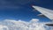 Airplane flight. wing of an airplane flying above the white clouds and blue sky. beautiful aerial view from the window