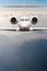 Airplane fly over clouds and Alps mountain on sunset. Front view of a big passenger or cargo aircraft, business jet