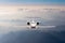 Airplane fly over clouds and Alps mountain on sunset. Front view of a big passenger or cargo aircraft, business jet