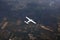 An airplane fly over the framland for travel