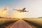 Airplane flying above empty road in rural landscape - travel co