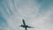 Airplane flying above the sea over cloudy sky