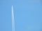 Airplane flying in the clear blue sky and contrail against, Engine exhaust contrails forming behind,  Jet contrails or trails over