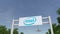 Airplane flying over advertising billboard with Intel Corporation logo. Editorial 3D rendering