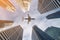 Airplane flying over city business buildings, high-rise skyscrapers