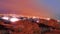 Airplane flying over farm in the desert outside the city at twilight