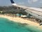 Airplane flying over St. Maarten beach