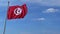 Airplane flying over waving flag of Tunisia