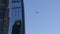 An airplane flying past a skyscraper in downtown Los Angeles