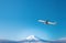 Airplane frying over the Snow Mountain Fuji background. view of Fuji-san, the highest mountain in Japan