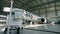 Airplane in hangar, rear view of aircraft and light from windows. Airplanes under repair in a maintenance hangar