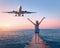 Airplane and happy woman at sunset. Summer landscape