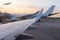 airplane jet waiting to runway on taxi lane in airport and aircraft traffic to take off with sunset background, view from window