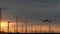 Airplane landing in LAX airport at sunset, Los Angeles, California USA. Passenger flight or cargo plane silhouette