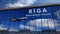 Airplane landing at Riga mirrored in terminal