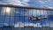 Airplane landing at Tallinn Estonia airport mirrored in terminal