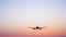 Airplane Lowering Ready for Landing at Airport, Silhouette against Beautiful Sunset