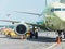 Airplane parked at the airport before departure, loading baggage