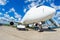 Airplane is parked at the airport with a gangway waiting for boarding of passengers.