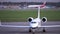 Airplane parked in an airport parking lot. Engine, wings, cockpit, close-up. 4K