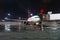 Airplane at passenger gangway of the terminal building at the airport at night, aircraft flight maintenance.