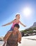 Airplane, piggyback and father with daughter at a beach for travel, fun or bonding in nature with freedom. Love, support