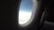 Airplane porthole view, aircraft flies high passenger pov flight