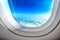 Airplane Porthole Window and Summer Clouds