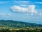 Airplane Shaped Cloud over green mountain