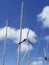 Airplane shaped wind indicator, aluminum masts, stringers and rigging of the sailboat against the blue tropical sky. Close up of