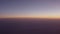 Airplane shot of flying over clouds in sunset