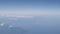 Airplane shot, flying over mountains with clouds over europe