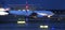 An airplane starting speed blur at an airport at night