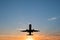 Airplane on sunset sky , aircraft silhouette scenic sky