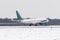 Airplane take off from the snow-covered runway airport in bad weather during a snow storm, a strong wind in the winter.