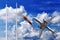 Airplane takes off in a beautiful summer sky with red and white windsock