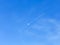Airplane track crosses the moon in the blue sky. Copy space for text