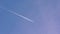 Airplane vapour trails across clear blue sky