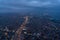 Airplane window from interior of aircraft with view of complex highway