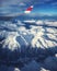 Airplane window view: airliner overflying the swiss-italian Alps