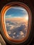 airplane window view to a blue cloudy sky