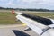 An airplane window view of wing and flaps after landing. Landing aircraft at the airport. Braking of the aircraft on the runway,