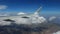 Airplane wing above the clouds and mountains