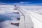 Airplane wing through the aircraft window. Greenhouse effect, global warming