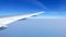 Airplane wing and clean blue sky